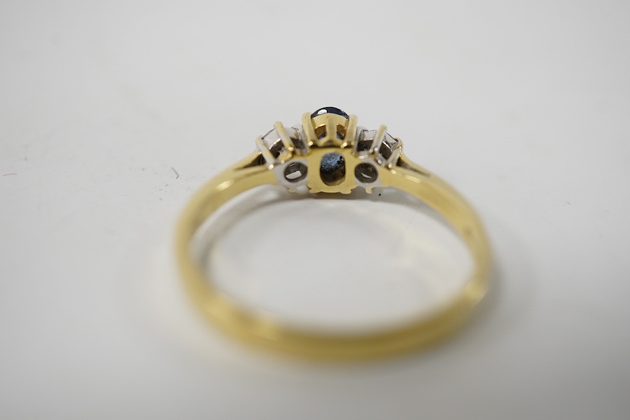 A modern 18ct gold, single stone sapphire and two stone diamond set ring, size Q, gross weight 3 grams. Condition - poor to fair